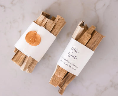 A bundle of Palo Santo sticks wrapped with a wax seal. The Palo Santo is ethically and sustainably sourced from fallen branches in Peru.